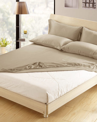 a bed with a white comforter and pillows