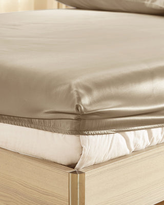 a close up of a bed with a sheet on it