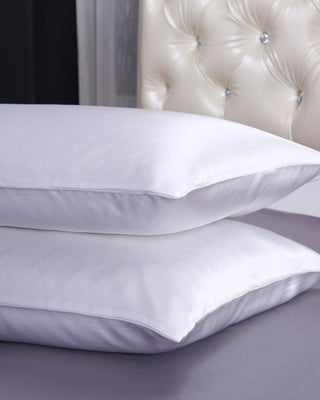 a pair of pillows on top of a bed