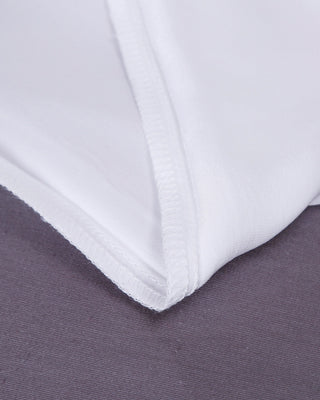 a close up of a white sheet on a bed