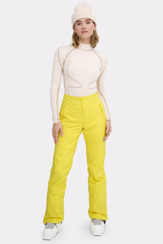 a woman in a white top and yellow pants