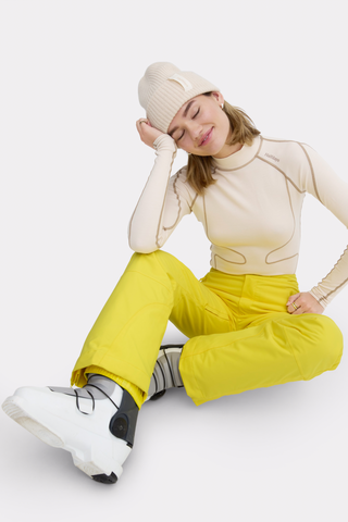 a woman sitting on the floor with her hands on her head