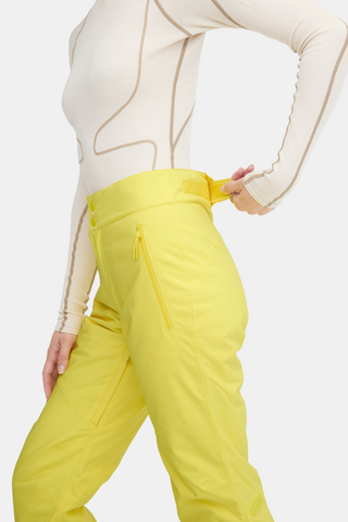 a woman in a white shirt and yellow pants