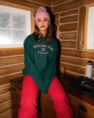 a woman sitting on a counter in a cabin