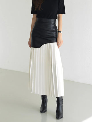 a woman in a black top and white skirt