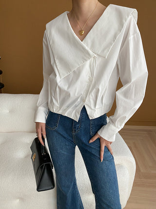 a woman wearing a white shirt and jeans