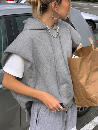 a woman is carrying a brown paper bag