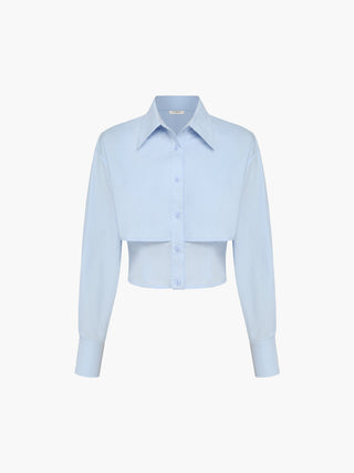 a light blue cropped shirt with long sleeves