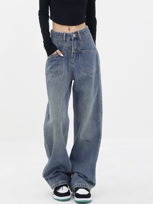 a woman wearing a black crop top and wide jeans