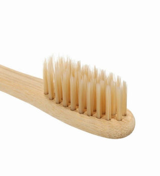 a wooden toothbrush on a white background