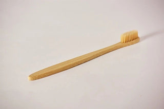 a wooden toothbrush on a white background