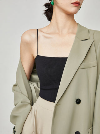 a woman in a green coat and black top