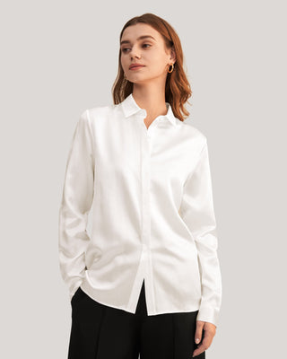 a woman wearing a white shirt and black pants