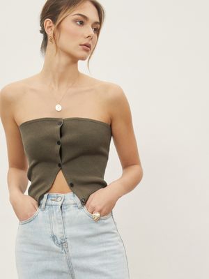 a model wearing a denim skirt and a crop top