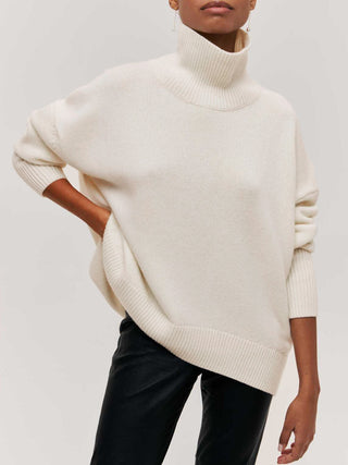 a woman wearing a white turtle neck sweater