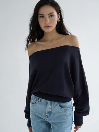 a woman wearing a black sweater and jeans