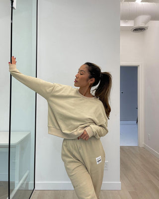 a woman standing in front of a mirror