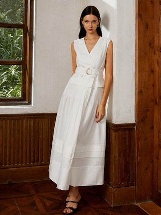 a woman in a white dress standing in front of a window