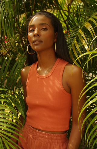 a woman standing in front of a tree