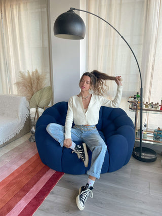 a woman sitting on a blue bean chair