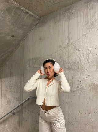 a woman in a white sweater and white pants