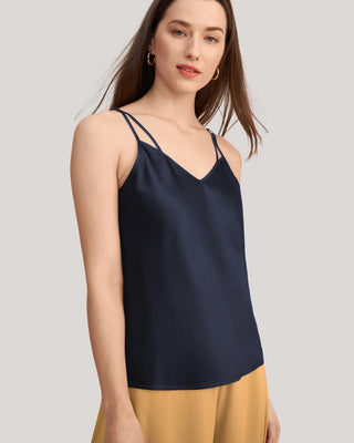 a woman wearing a navy blue top with spaghetti straps