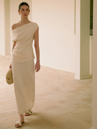 a woman in a white dress standing in a room