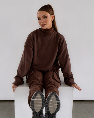 a woman sitting on top of a white box