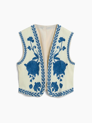 a white vest with blue flowers on it