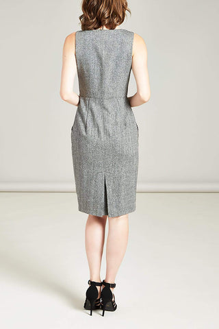 the back view of a woman wearing a grey tweed dress