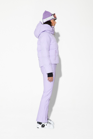 a man in a purple jacket and white sneakers