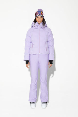 a woman wearing a purple ski suit