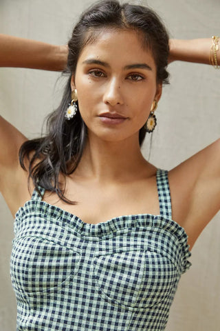 a woman wearing a green and white checkered top