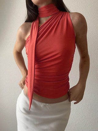 a woman wearing a red top and white skirt