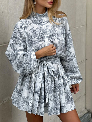 a woman wearing a white and black floral print shirt dress