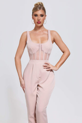 a woman wearing a blush pink jumpsuit