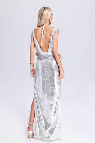 a woman wearing a silver dress with a back cut out