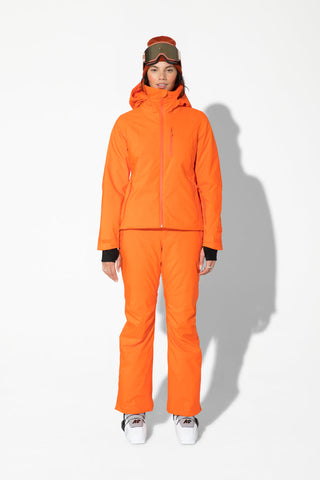 a woman wearing an orange ski suit