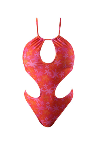 a woman in a pink and orange floral print swimsuit