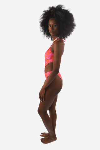 a woman in a pink swimsuit and black hair