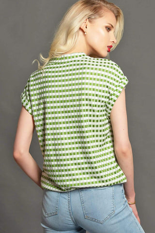 a woman wearing a green and white checkered top