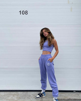 a woman standing in front of a white garage door