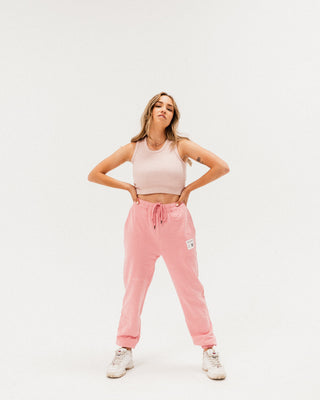 a woman in a pink crop top and pink sweat pants