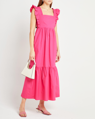 a woman wearing a pink midi dress