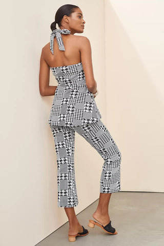 a woman wearing a black and white patterned jumpsuit