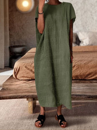 a woman in a green dress standing on a bed