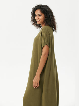 a woman wearing a green t - shirt dress