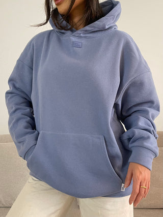 a woman wearing a blue hoodie sweatshirt