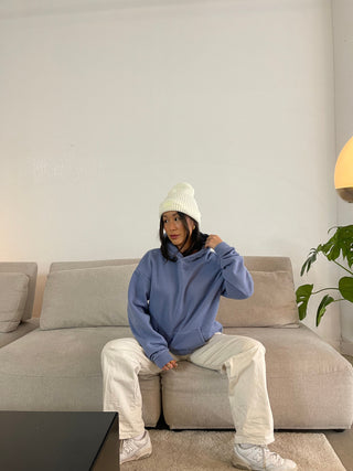 a woman sitting on a couch in a living room