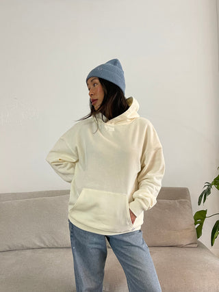 a woman standing on a couch in a living room